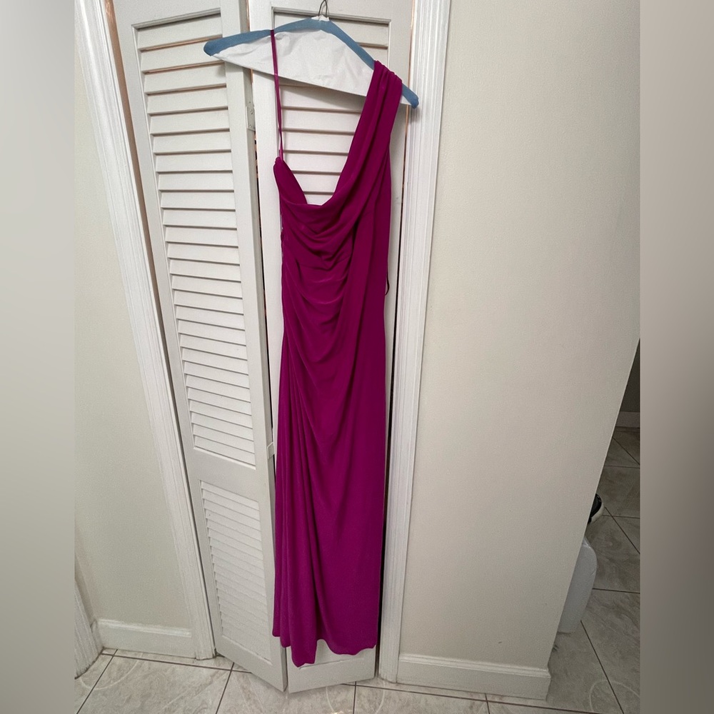 This fuchsia colored long dress is perfect for any occasion. It is one shoulder.